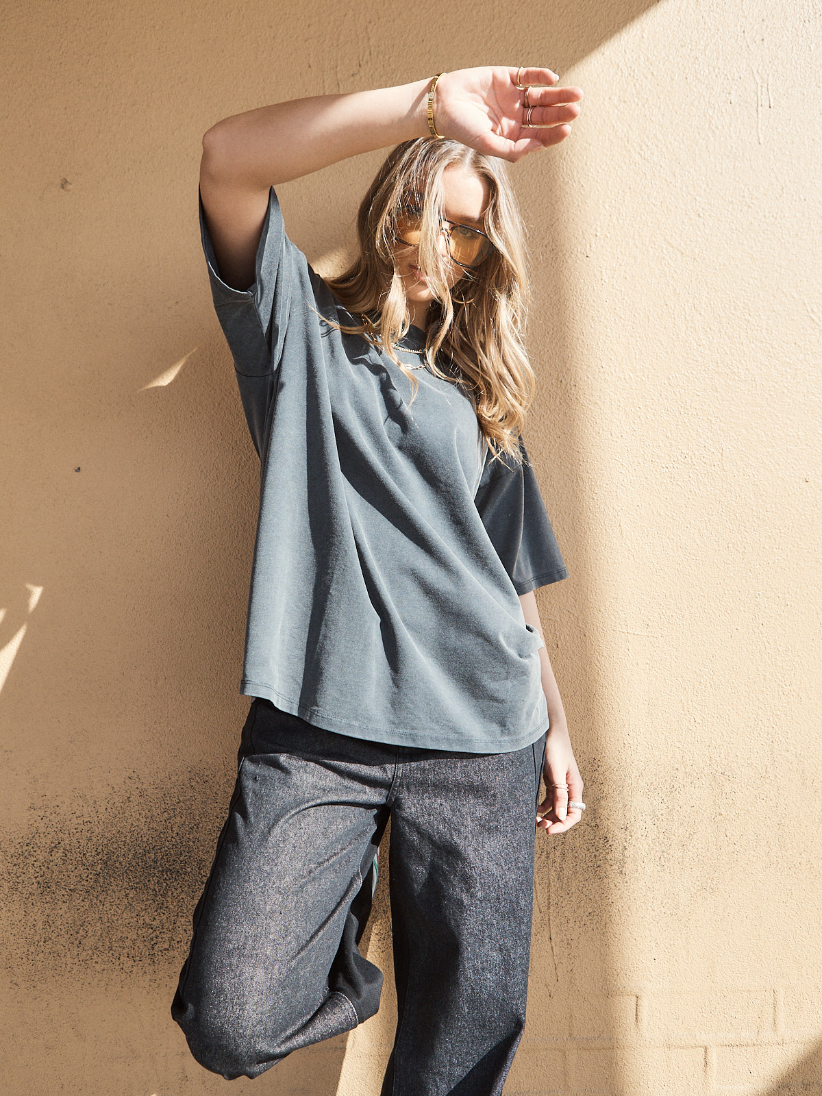 Close-up of unisex oversized washed black crew neck tee with relaxed fit.