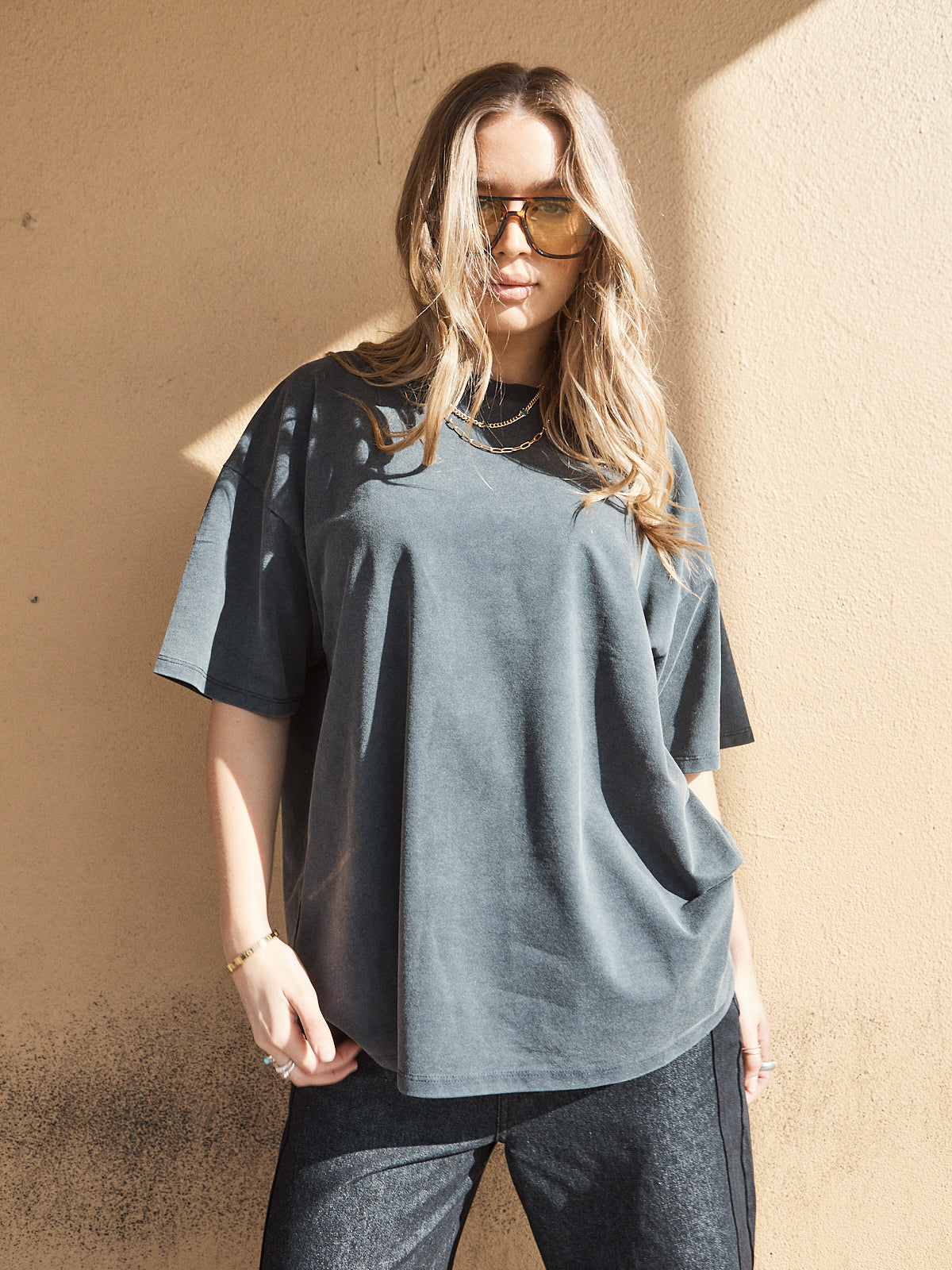 Close-up of unisex oversized washed black crew neck tee with relaxed fit.